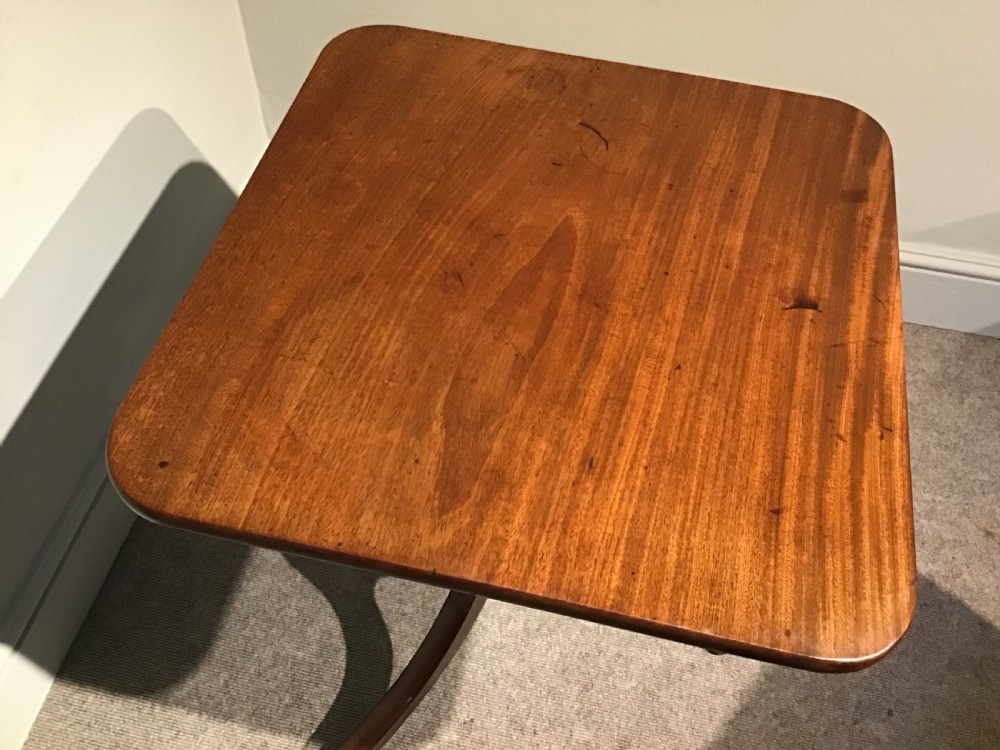 A Georgian mahogany tripod table featuring a square top with rounded corners, supported by a turned central pedestal and three splayed legs. View VI