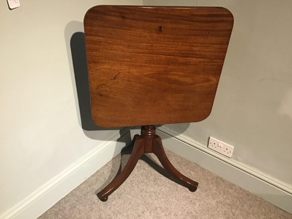 A Georgian mahogany tripod table featuring a square top with rounded corners, supported by a turned central pedestal and three splayed legs. View VII