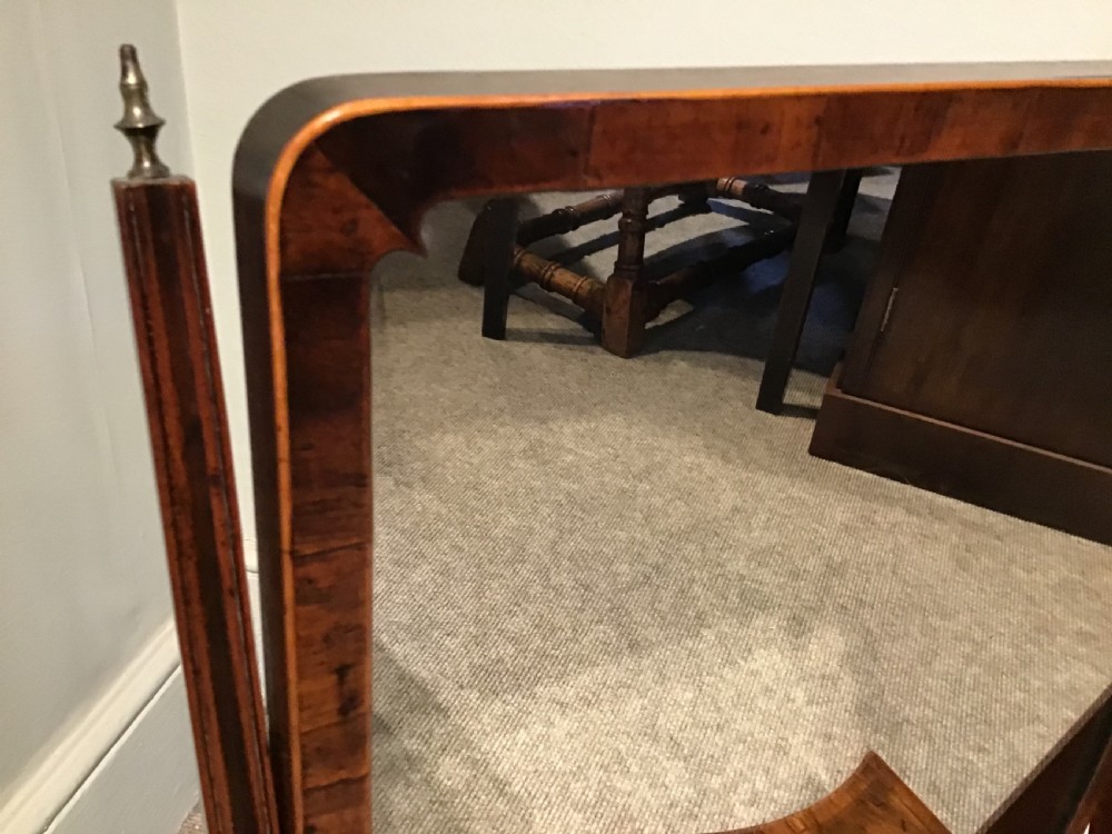 A Georgian mahogany toilet mirror featuring an adjustable glass plate set within vertical posts above a serpentine box base with drawers. View VII