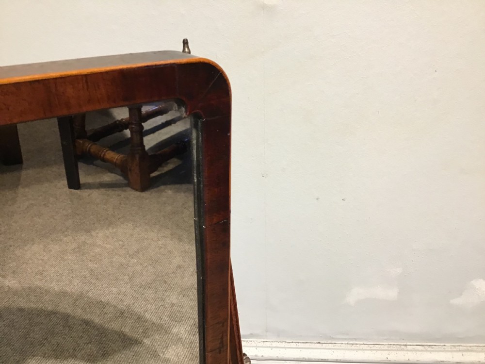 A Georgian mahogany toilet mirror featuring an adjustable glass plate set within vertical posts above a serpentine box base with drawers. View VIII