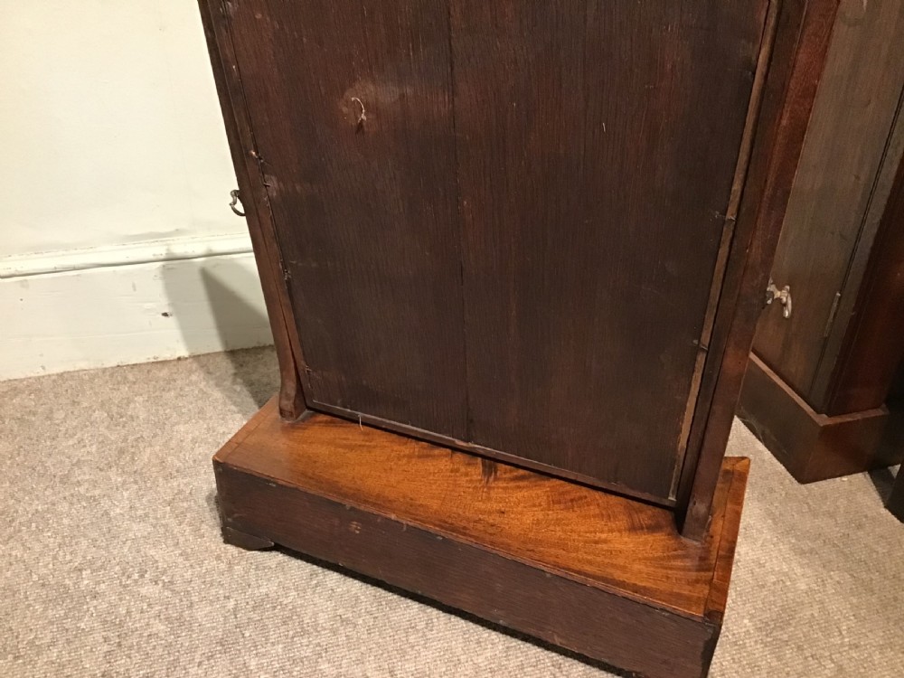 A Georgian mahogany toilet mirror featuring an adjustable glass plate set within vertical posts above a serpentine box base with drawers. View XI