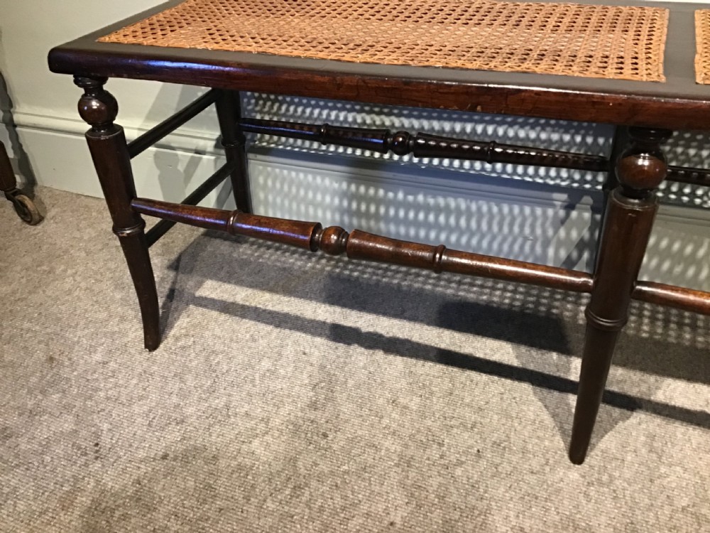 An antique beech and cane long stool View IV