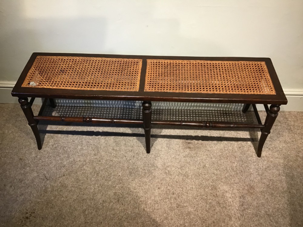 An antique beech and cane long stool View VI