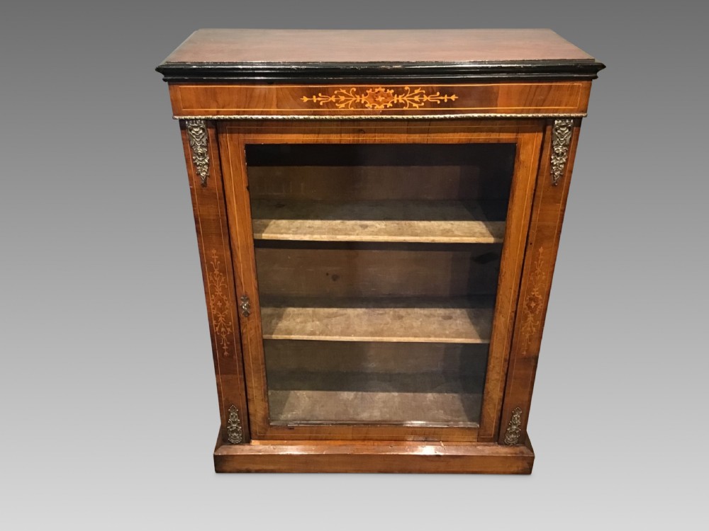 Victorian walnut pier cabinet with floral marquetry inlay, single glazed door, three internal shelves, and metal ormolu mounts.