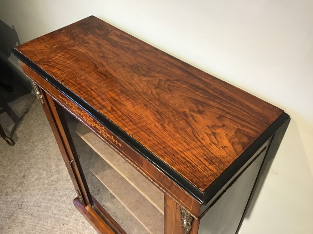 Victorian walnut pier cabinet with floral marquetry inlay, single glazed door, three internal shelves, and metal ormolu mounts. View V
