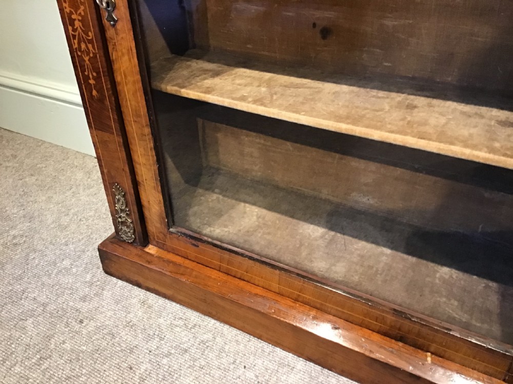 Victorian walnut pier cabinet with floral marquetry inlay, single glazed door, three internal shelves, and metal ormolu mounts. View VI