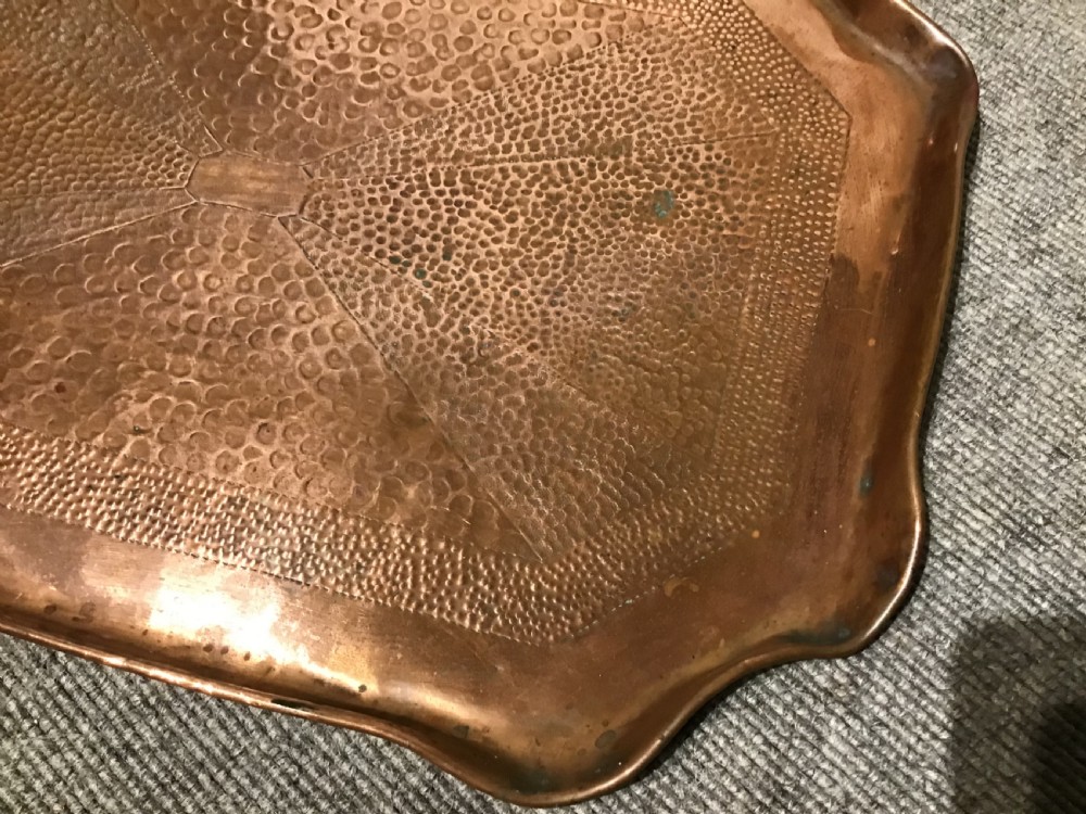 A rectangular Arts and Crafts hand-hammered copper tray featuring a raised scalloped rim and geometric textured surface patterns. View II