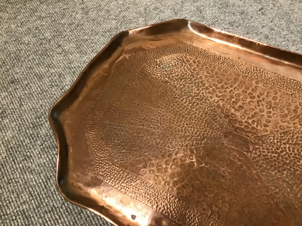 A rectangular Arts and Crafts hand-hammered copper tray featuring a raised scalloped rim and geometric textured surface patterns. View III