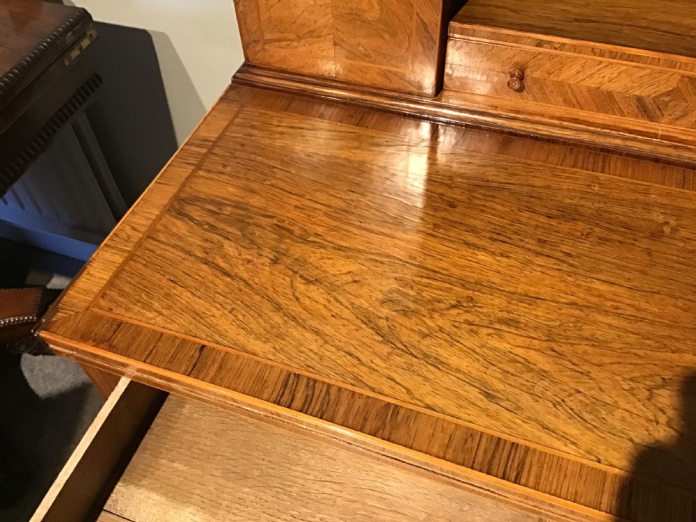 A rosewood bonheur du jour writing desk featuring geometric parquetry veneers, square tapered legs, a frieze drawer, and a raised cabinet top with brass fretwork rail. View VIII