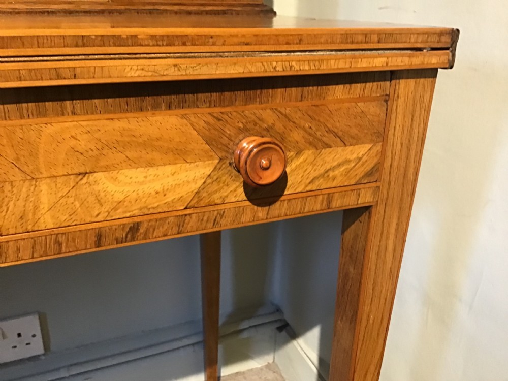 A rosewood bonheur du jour writing desk featuring geometric parquetry veneers, square tapered legs, a frieze drawer, and a raised cabinet top with brass fretwork rail. View XI