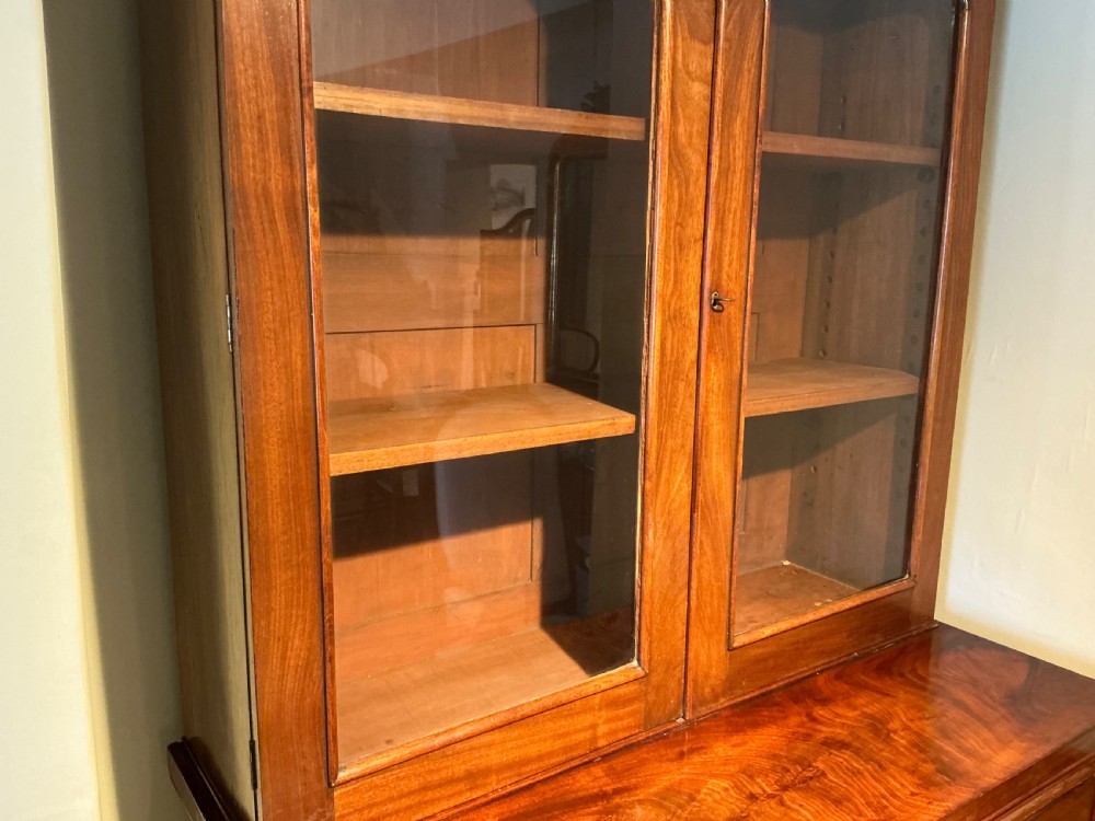 A Victorian mahogany secretaire bookcase featuring an upper glazed two-door cabinet, a central secretaire drawer with turned wooden handles, and a lower double-door cupboard. View II