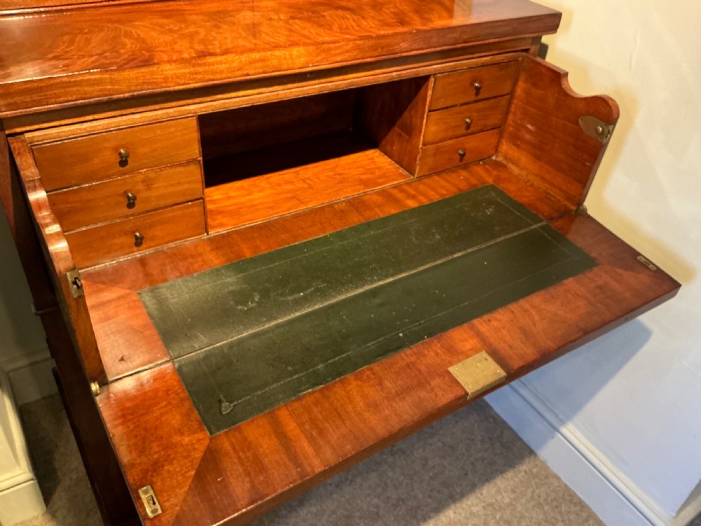 A Victorian mahogany secretaire bookcase featuring an upper glazed two-door cabinet, a central secretaire drawer with turned wooden handles, and a lower double-door cupboard. View V