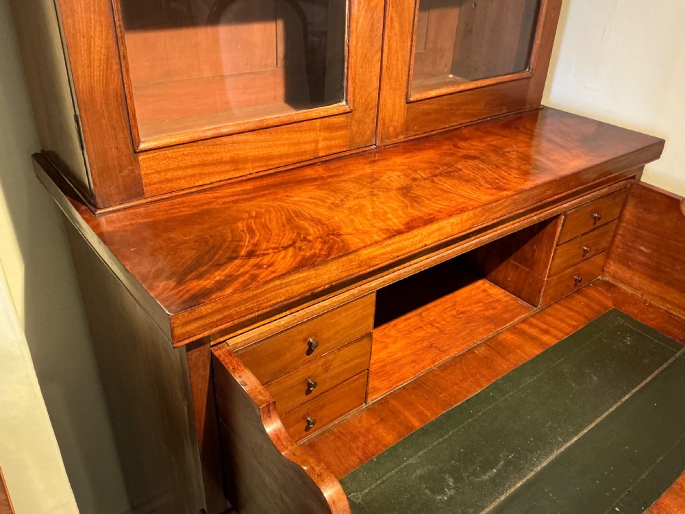 A Victorian mahogany secretaire bookcase featuring an upper glazed two-door cabinet, a central secretaire drawer with turned wooden handles, and a lower double-door cupboard. View VI