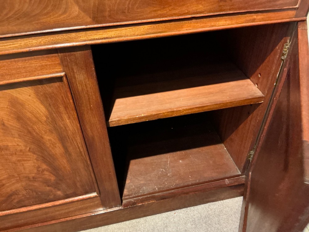 A Victorian mahogany secretaire bookcase featuring an upper glazed two-door cabinet, a central secretaire drawer with turned wooden handles, and a lower double-door cupboard. View IX