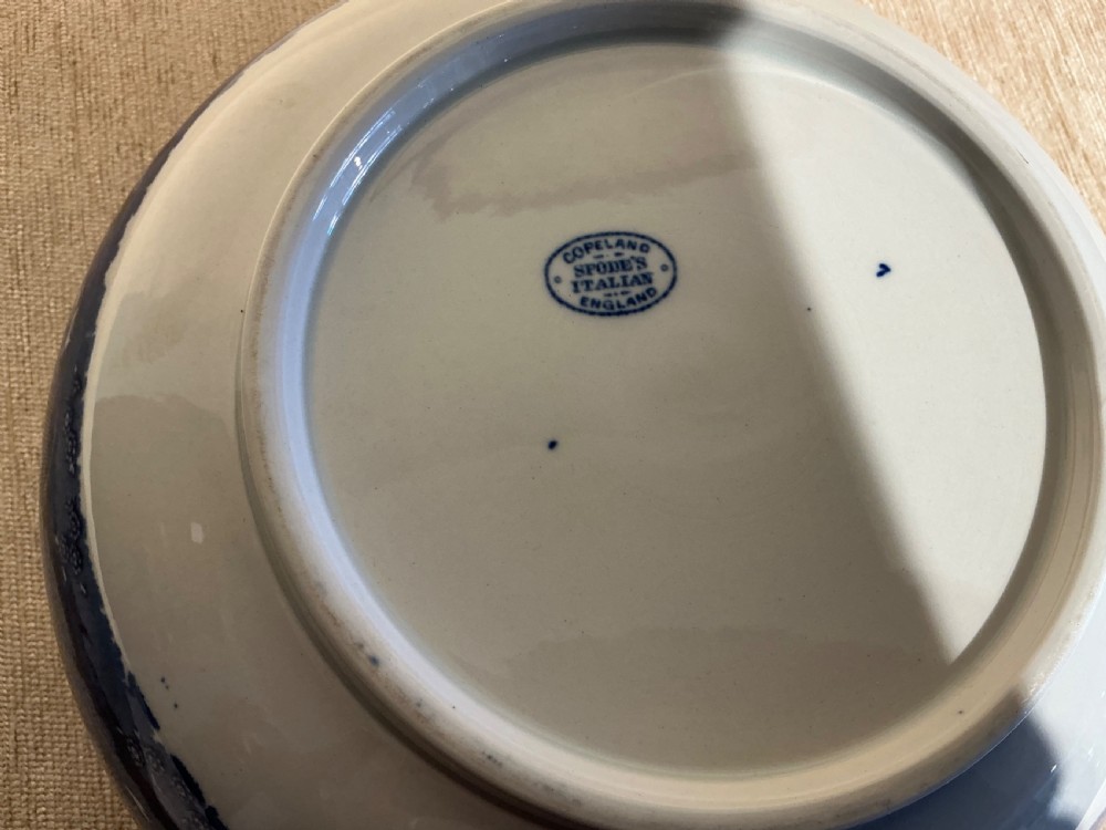 A deep Victorian ceramic bowl decorated inside and out with blue and white underglaze transfer-printed pastoral landscape scenes and an intricate floral border. View III