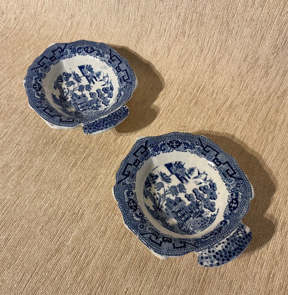 A pair of small, leaf-shaped blue and white ceramic pickle dishes decorated in the traditional Willow transferware pattern. View III