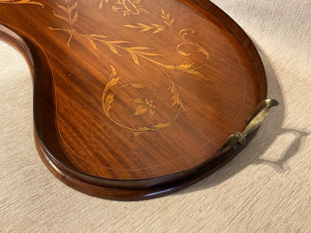A kidney-shaped mahogany tray featuring inlaid satinwood leaf scrolls and a central urn motif, complete with twin brass handles and a raised gallery edge. View IV