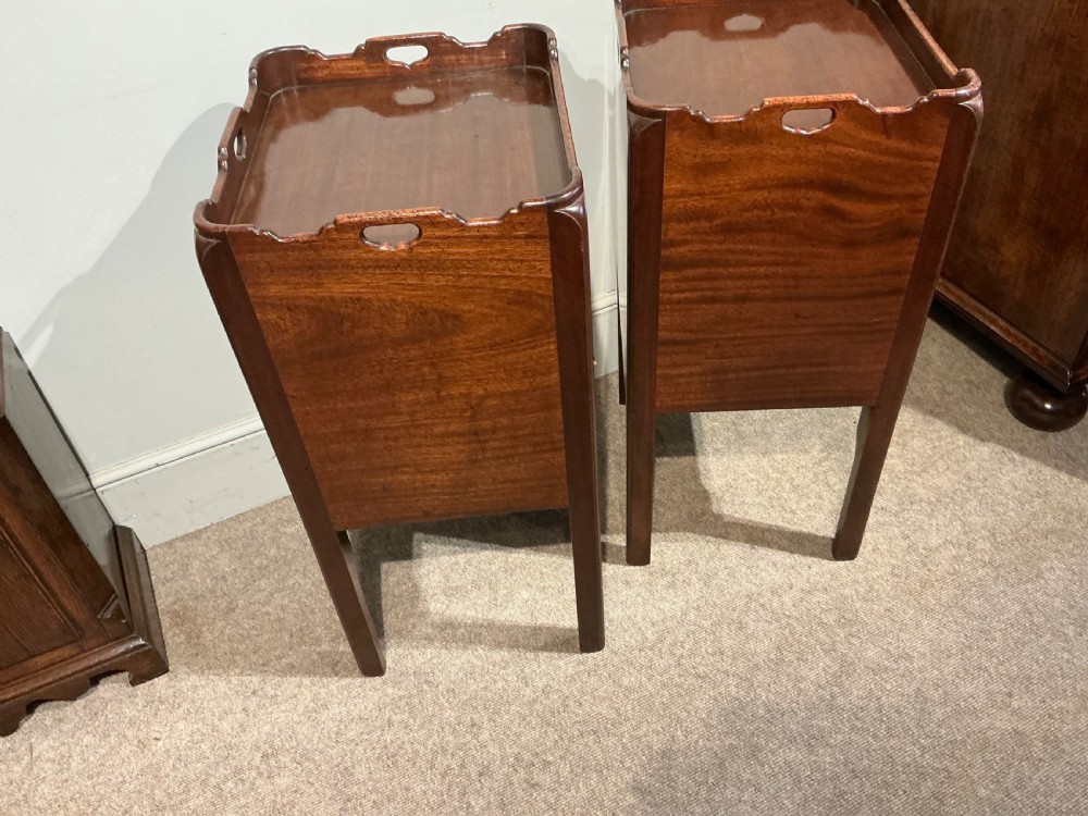 A pair of antique dark mahogany bedside cabinets featuring tray tops with carved handles, slatted tambour sliding doors, single drawers with brass handles, and square legs. View VIII