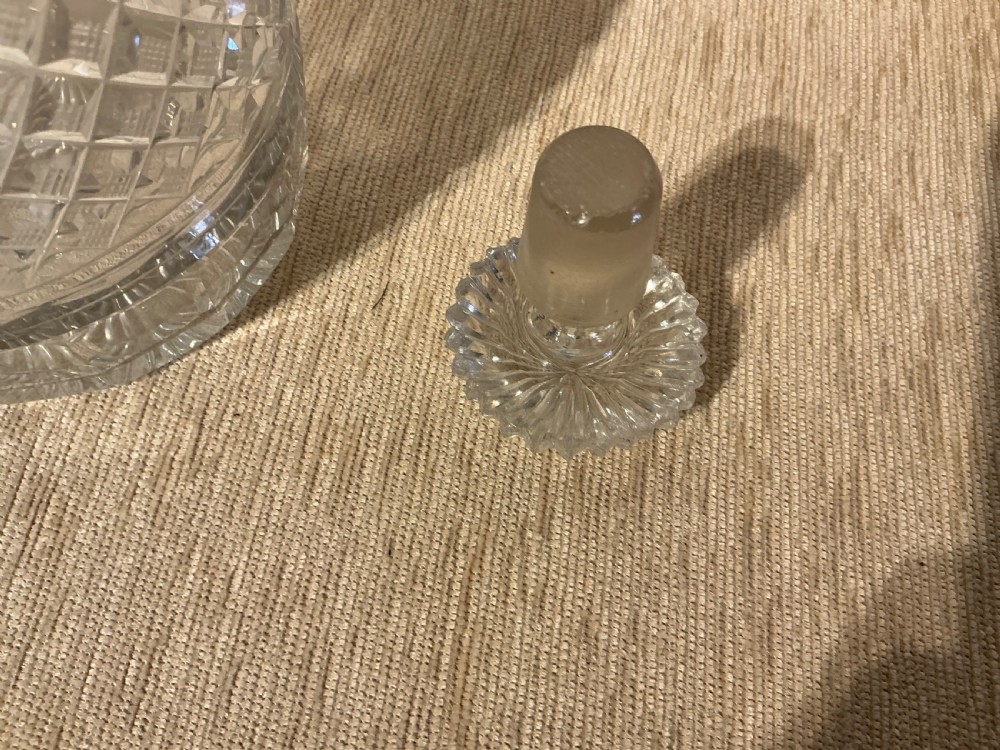 A pair of late Georgian clear cut-glass decanters featuring stepped neck rings, diamond pattern bands, and flat mushroom stoppers. View VI