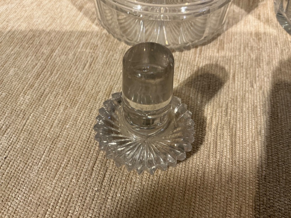 A pair of late Georgian clear cut-glass decanters featuring stepped neck rings, diamond pattern bands, and flat mushroom stoppers. View VIII