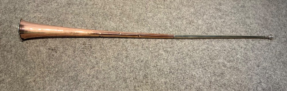 A long straight late Victorian coaching horn featuring a tapered copper body and a silver-toned metal mouthpiece.