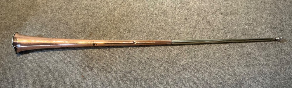 A long straight late Victorian coaching horn featuring a tapered copper body and a silver-toned metal mouthpiece. View III