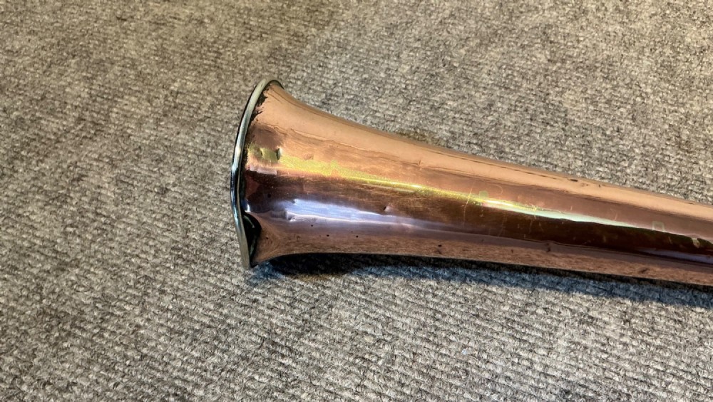 A long straight late Victorian coaching horn featuring a tapered copper body and a silver-toned metal mouthpiece. View IV