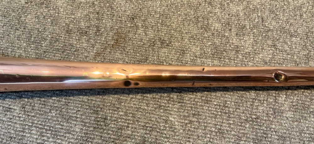 A long straight late Victorian coaching horn featuring a tapered copper body and a silver-toned metal mouthpiece. View V