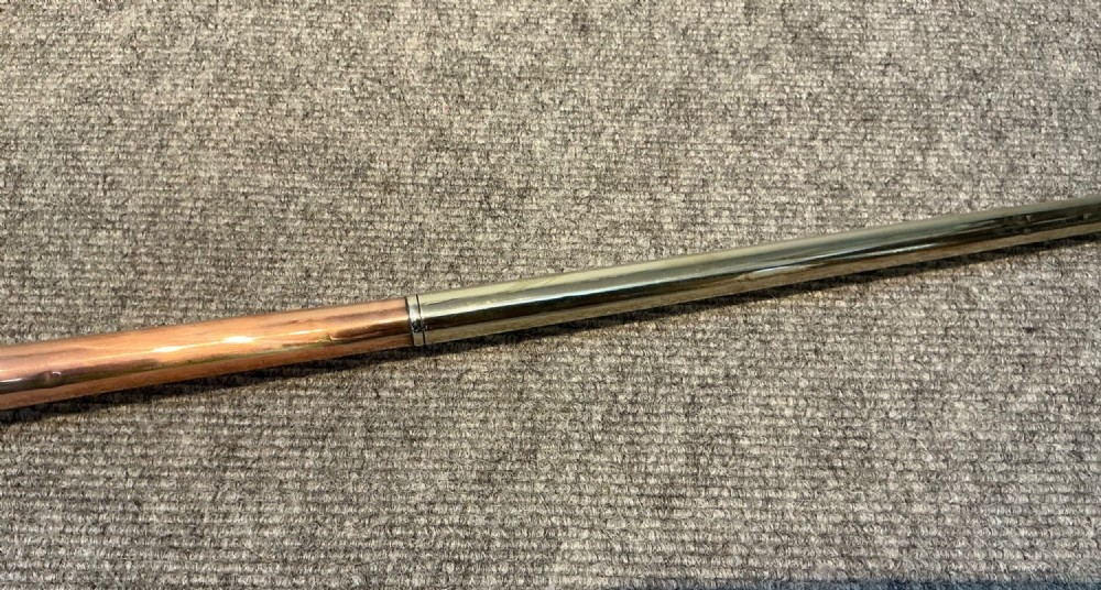 A long straight late Victorian coaching horn featuring a tapered copper body and a silver-toned metal mouthpiece. View VI