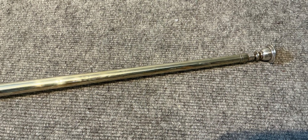 A long straight late Victorian coaching horn featuring a tapered copper body and a silver-toned metal mouthpiece. View VII