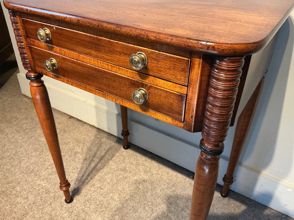 An early nineteenth-century mahogany and maple work table featuring two drawers with brass knobs, reeded upper corner detailing, and turned legs. View IV