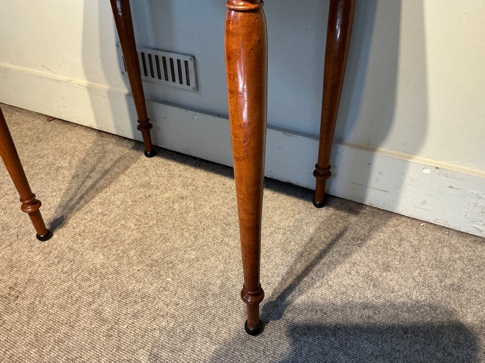 An early nineteenth-century mahogany and maple work table featuring two drawers with brass knobs, reeded upper corner detailing, and turned legs. View V