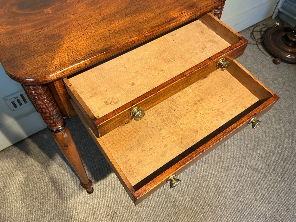 An early nineteenth-century mahogany and maple work table featuring two drawers with brass knobs, reeded upper corner detailing, and turned legs. View VIII
