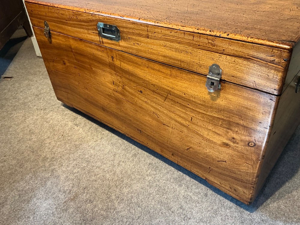 A rectangular antique camphorwood trunk with recessed metal handles and front latches. View V