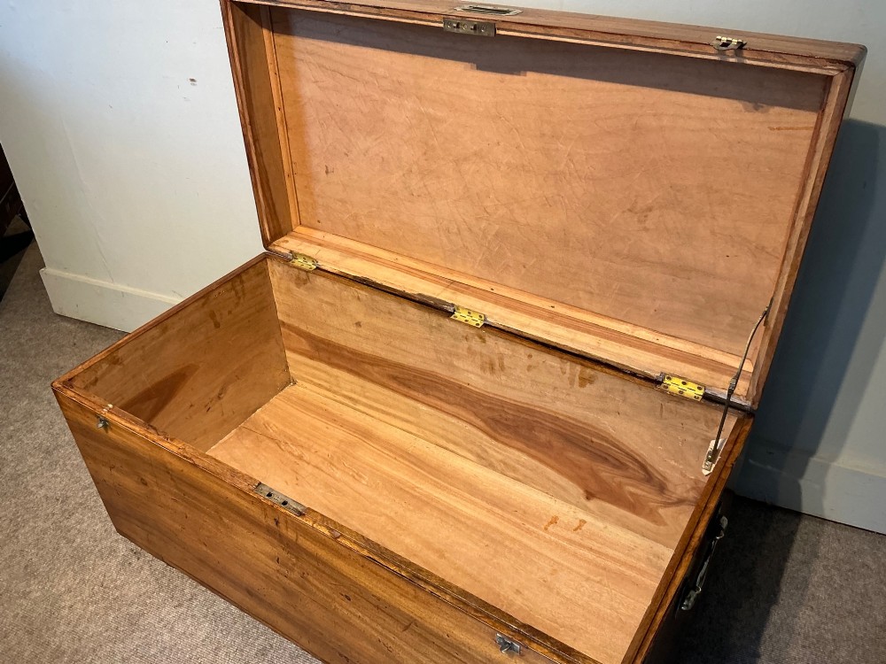 A rectangular antique camphorwood trunk with recessed metal handles and front latches. View VII