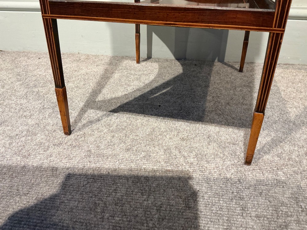 A late Georgian Sheraton mahogany work table featuring satinwood crossbanding, a single drawer, tapered square legs, and a concave lower undertier. View IX