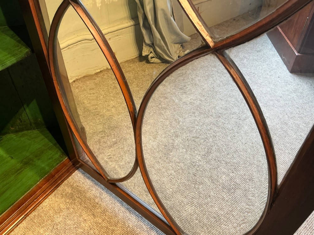 A Georgian mahogany wall-hanging corner cabinet featuring a moulded cornice and a single glass door with geometric oval astragal glazing bars. View VIII