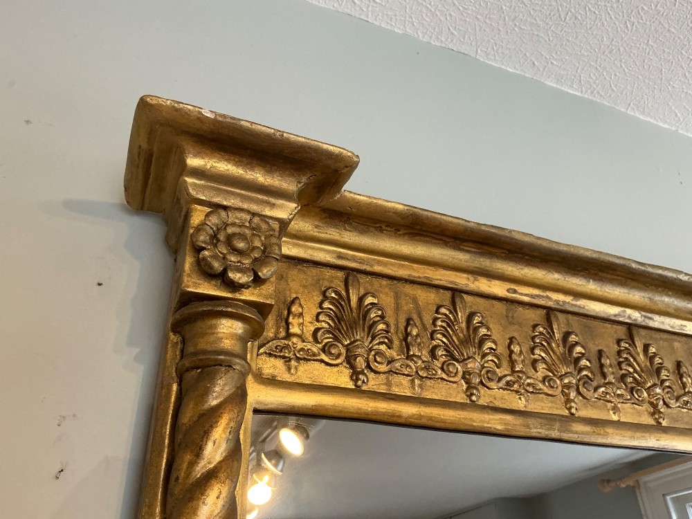 A horizontal Regency giltwood overmantel mirror featuring an anthemion frieze across the top and spiral-twist side columns. View III