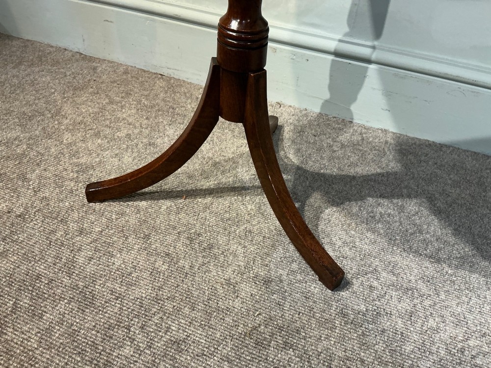 An antique dark mahogany wine table featuring a circular top supported by a turned central column on a tripod base. View V