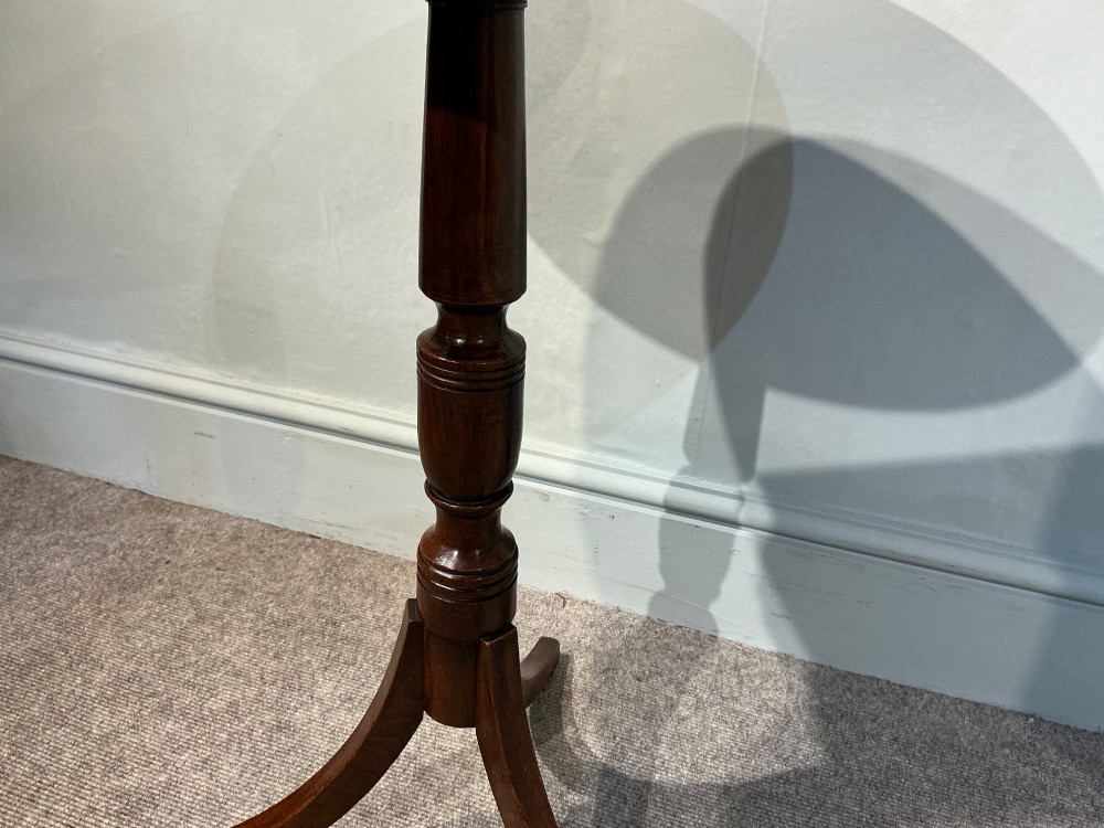 An antique dark mahogany wine table featuring a circular top supported by a turned central column on a tripod base. View VI