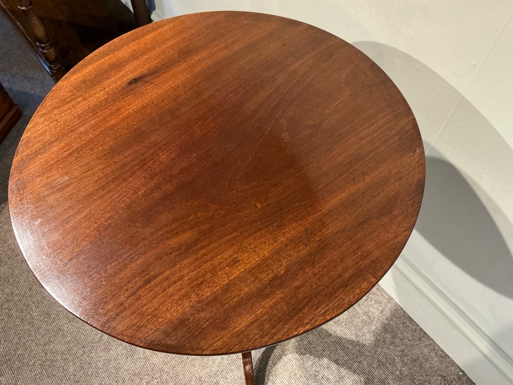An antique dark mahogany wine table featuring a circular top supported by a turned central column on a tripod base. View VIII