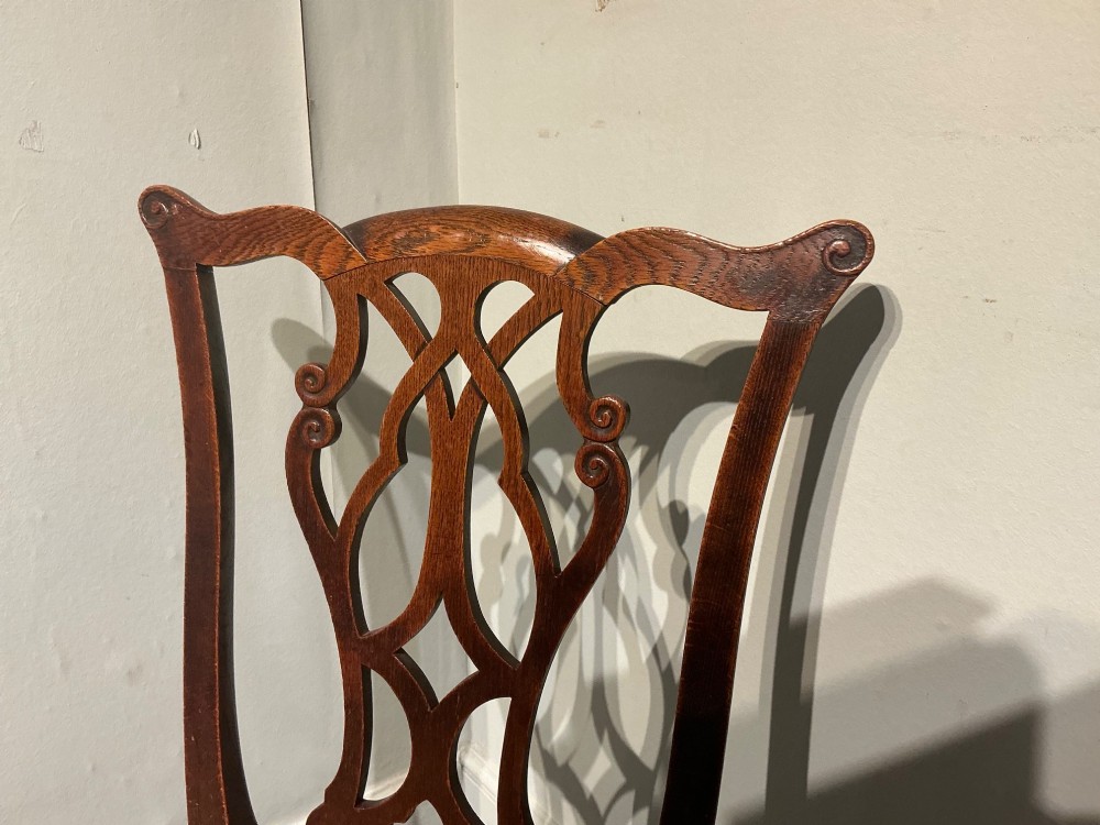 An antique dark oak side chair with an intricate pierced scroll splat back and a light brown upholstered drop-in seat. View III