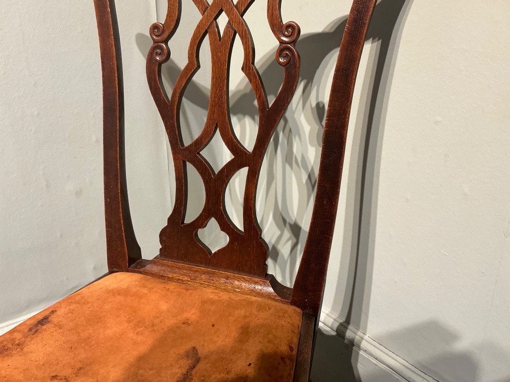 An antique dark oak side chair with an intricate pierced scroll splat back and a light brown upholstered drop-in seat. View IV
