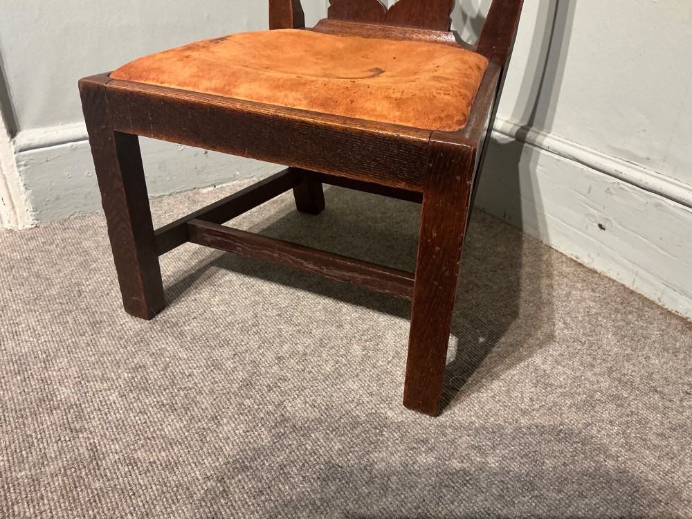 An antique dark oak side chair with an intricate pierced scroll splat back and a light brown upholstered drop-in seat. View V