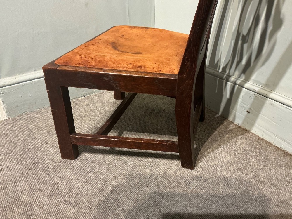 An antique dark oak side chair with an intricate pierced scroll splat back and a light brown upholstered drop-in seat. View VI