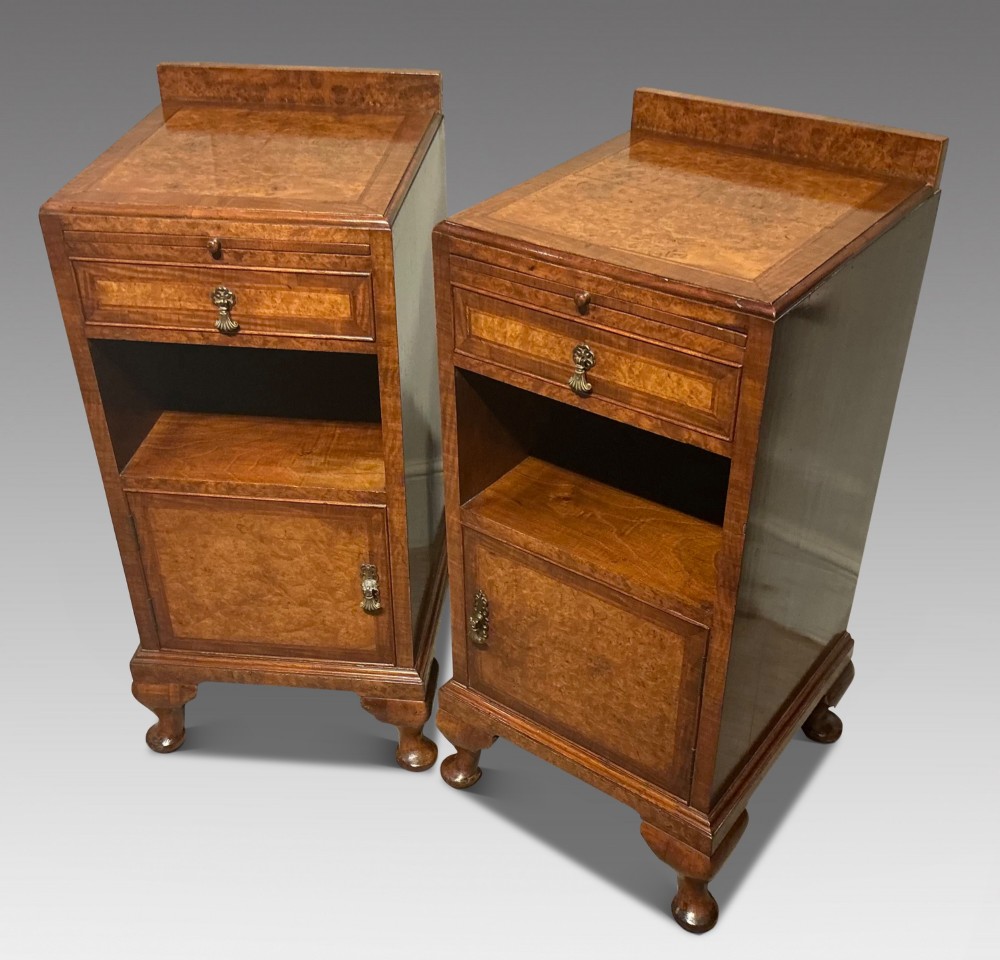 A matching pair of burr walnut bedside cabinets featuring pull-out slides, single drawers, open cubbies, lower cupboard doors, and cabriole legs. View II
