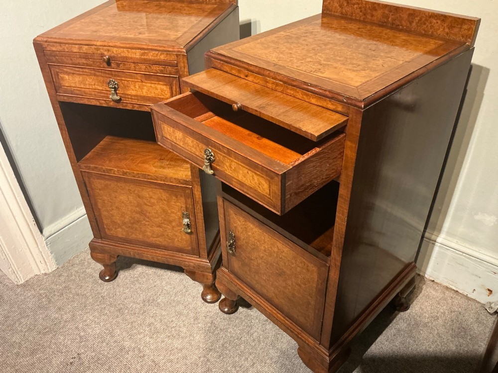 A matching pair of burr walnut bedside cabinets featuring pull-out slides, single drawers, open cubbies, lower cupboard doors, and cabriole legs. View III