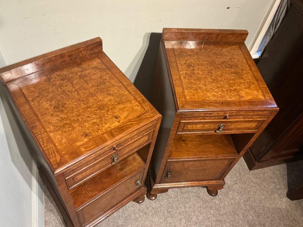 A matching pair of burr walnut bedside cabinets featuring pull-out slides, single drawers, open cubbies, lower cupboard doors, and cabriole legs. View VI