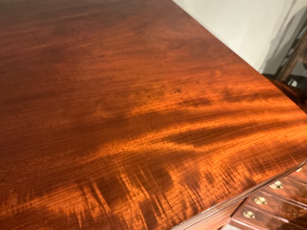 A Victorian mahogany chest of drawers featuring two short drawers over three long drawers with turned wooden knobs and flame veneer fronts. View VIII