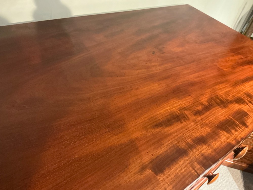 A Victorian mahogany chest of drawers featuring two short drawers over three long drawers with turned wooden knobs and flame veneer fronts. View IX